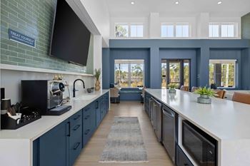 A kitchen with dark blue cabinets and a white countertop at The Quinn Luxury Apartments, Pensacola 32526